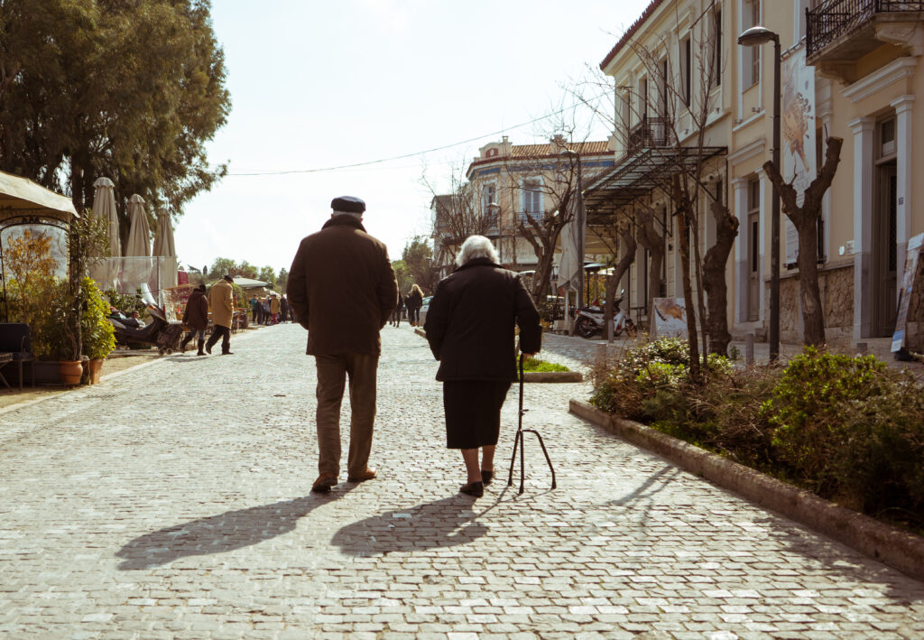 Learn Greek Hub mature couple walking in a street of athens